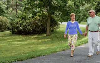 Older couple walking holding hands at not-for-profit