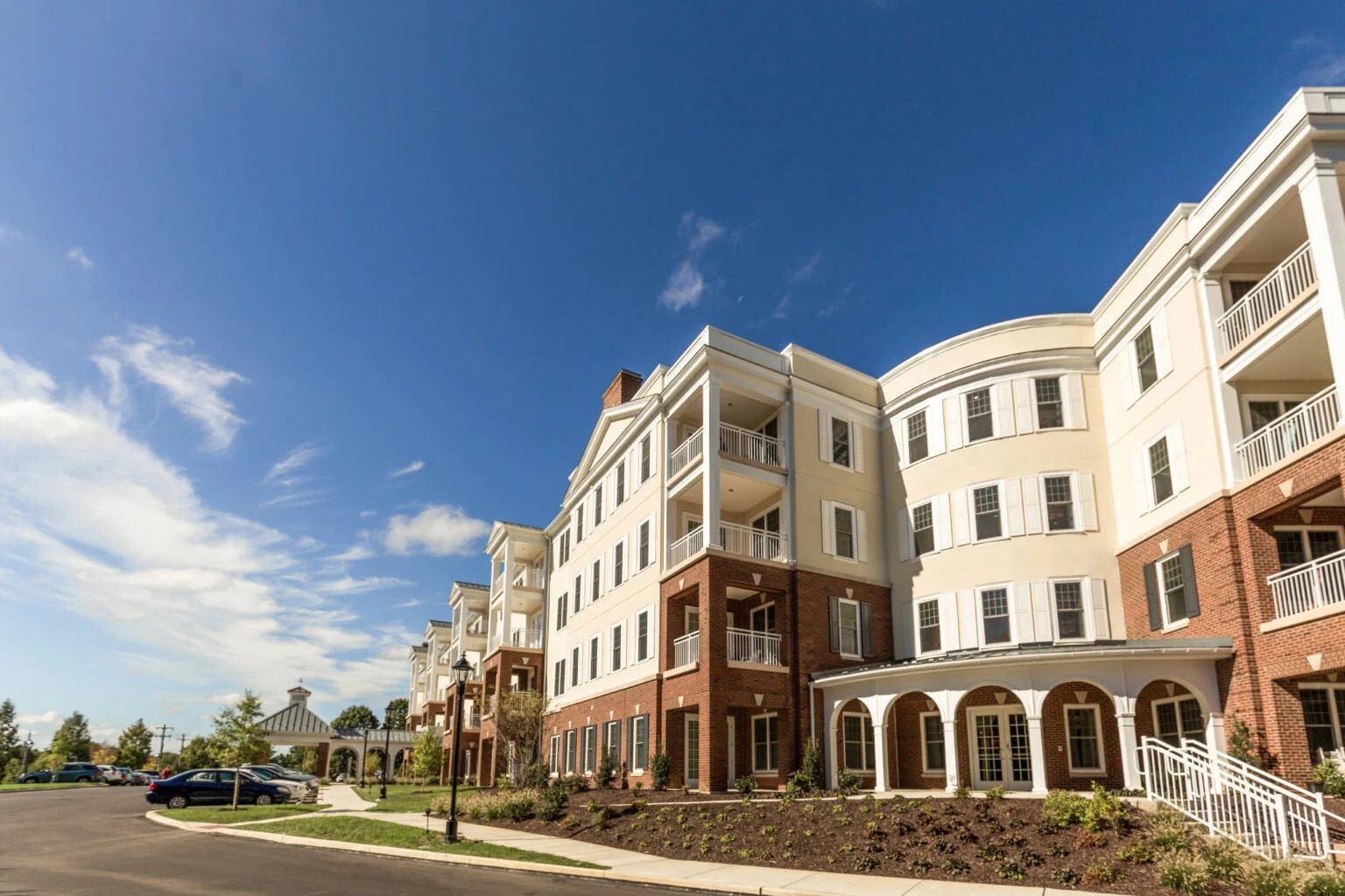 Exterior side of building of Masonic Village at Lafayette Hill, a large tan and brick building with balconies.