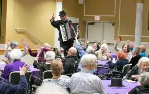 Man playing accordion for crowd
