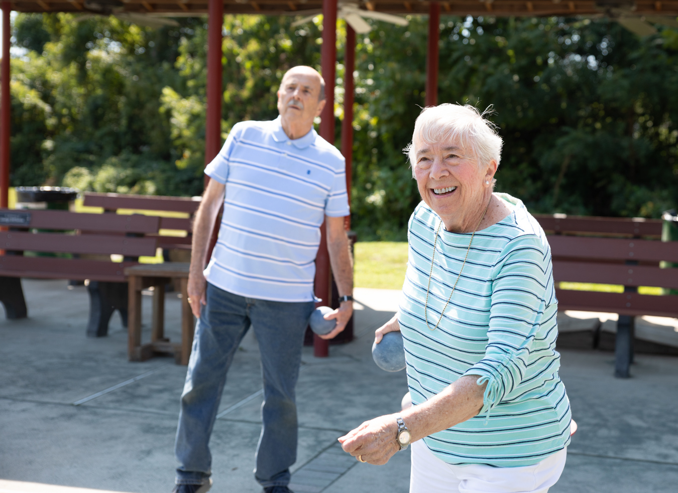 DU3A4504 Smiling woman playing bocce with man in the background