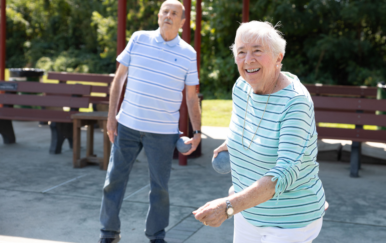 Smiling woman playing bocce