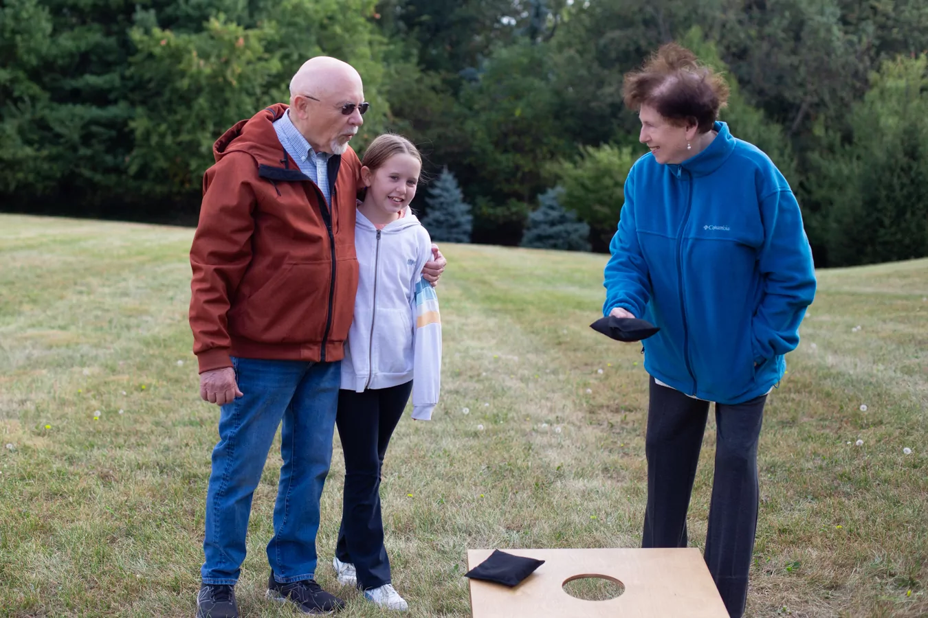 group playin cornhole with grandchild
