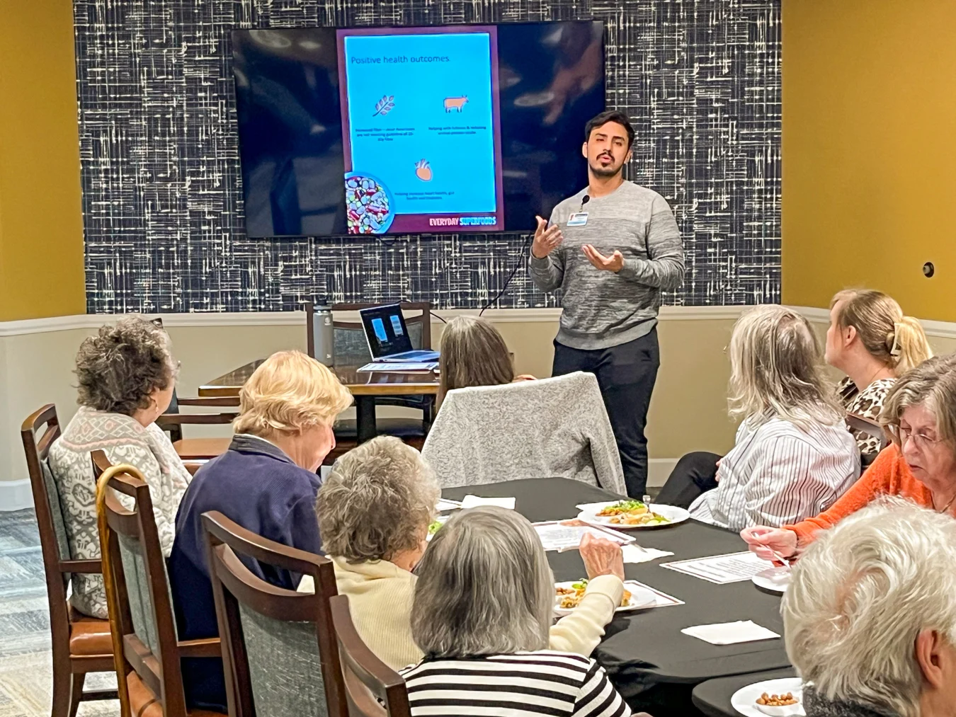 Man presenting to group. Man presenting in front of a room.